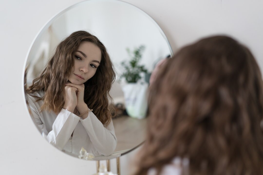 person reflecting in mirror